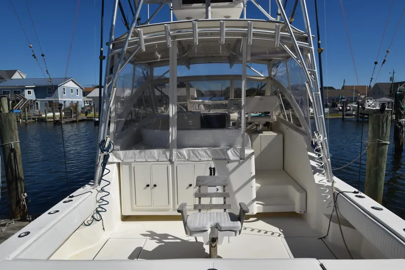 Barbara Ann Yacht Photos Pics 2001 Carolina Classic 35 Express boat docked at marina, featuring spacious cockpit and clear enclosure.