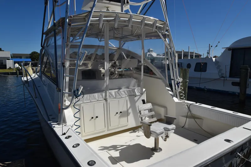 Barbara Ann Yacht Photos Pics 2001 Carolina Classic 35 Express boat docked, featuring spacious deck and fishing chair.