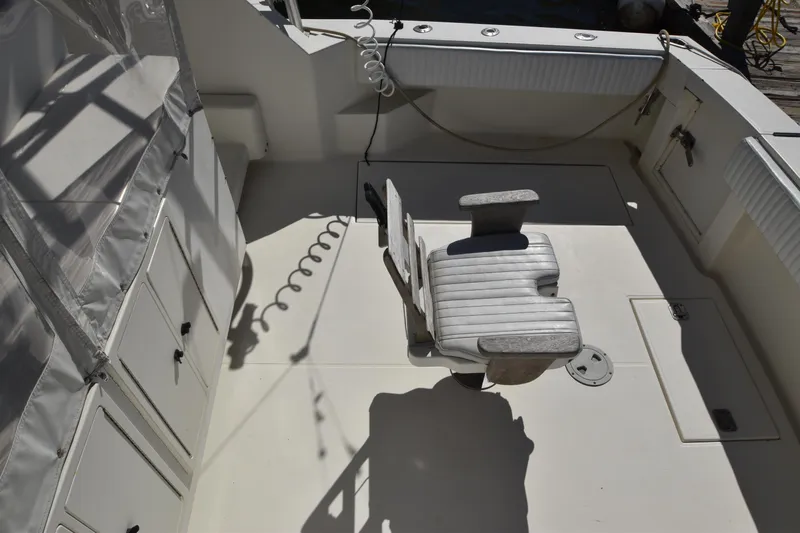 Barbara Ann Yacht Photos Pics 2001 Carolina Classic 35 Express boat deck with fishing chair and storage compartments.