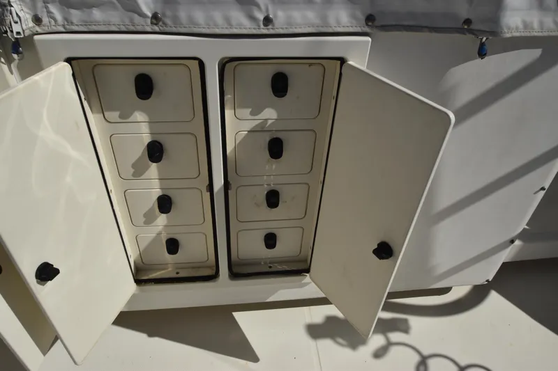 Barbara Ann Yacht Photos Pics Storage compartments on a 2001 Carolina Classic 35 Express boat, with open doors revealing drawers.