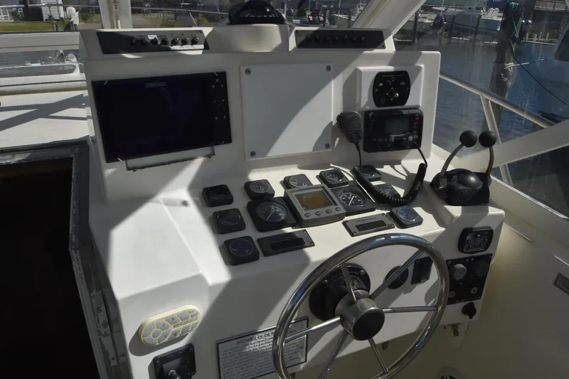 Barbara Ann Yacht Photos Pics Helm of 2001 Carolina Classic 35 Express with navigation instruments and steering wheel.