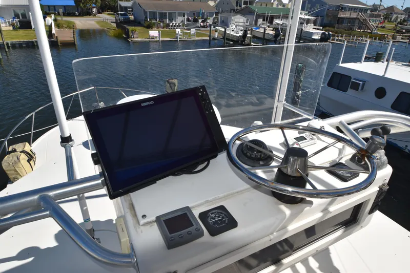 Barbara Ann Yacht Photos Pics Helm of 2001 Carolina Classic 35 Express with navigation equipment and steering wheel.