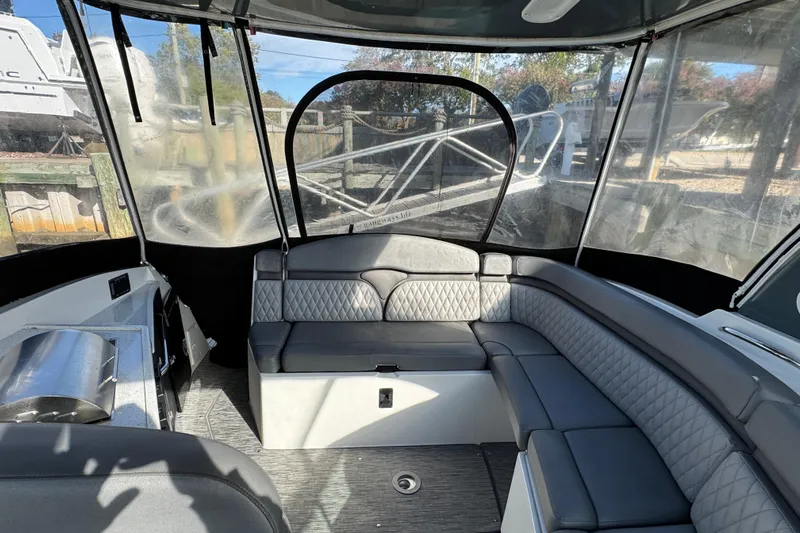  Yacht Photos Pics 2020 Rinker 320 EX boat interior with gray seating and clear canopy.