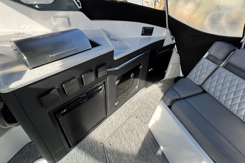  Yacht Photos Pics 2020 Rinker 320 EX boat interior with kitchenette and seating area.