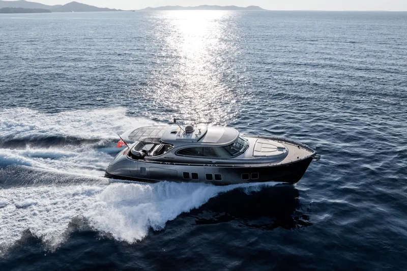 Loloma Yacht Photos Pics 2025 Zeelander 7 yacht cruising on open sea with scenic sunset backdrop.