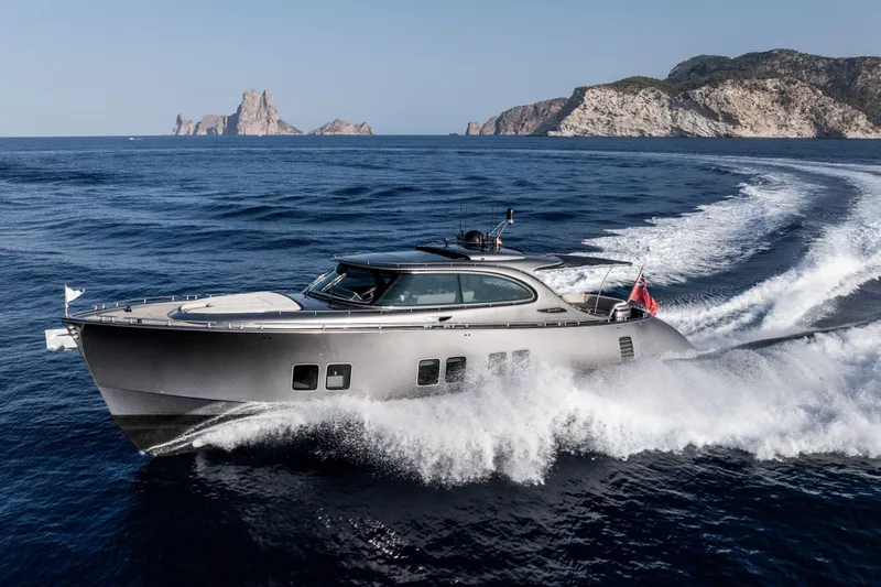 Loloma Yacht Photos Pics Luxurious 2025 Zeelander 7 yacht cruising in open sea near rocky coastline.