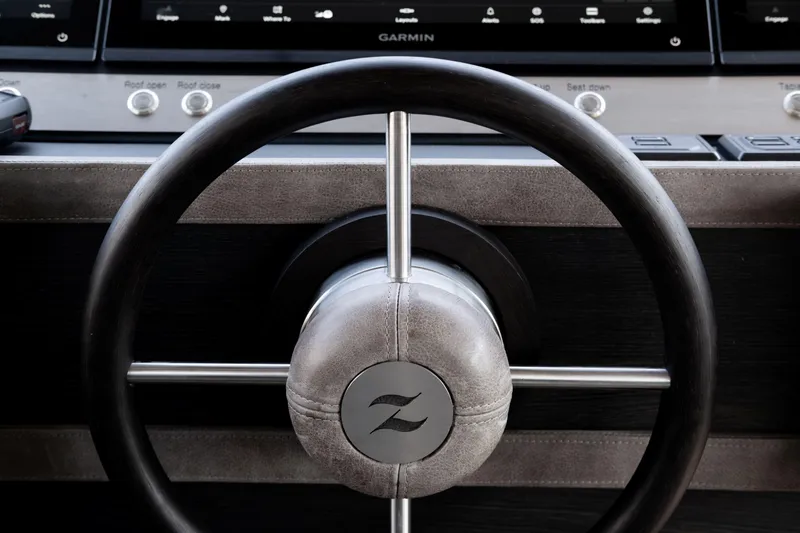 Loloma Yacht Photos Pics Steering wheel of 2025 Zeelander 7 yacht with modern dashboard controls.