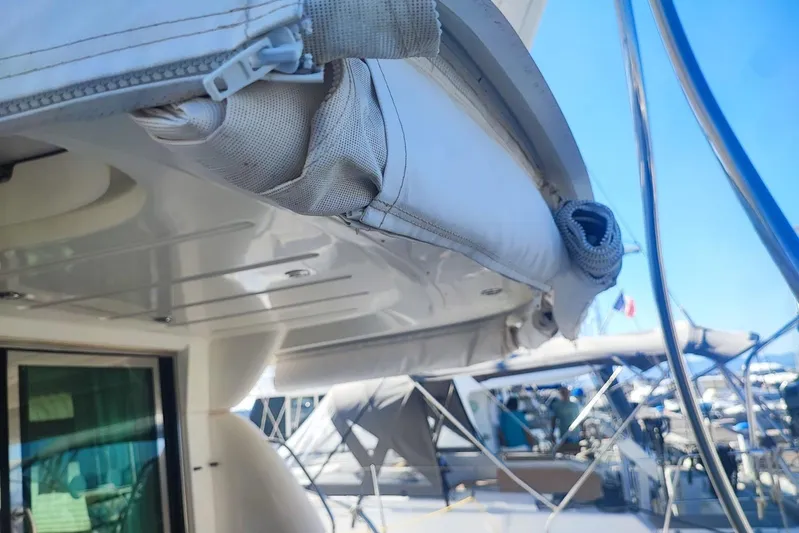  Yacht Photos Pics 2007 Prestige 46 yacht with rolled-up canopy, docked at marina under clear blue sky.