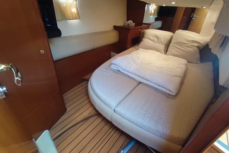  Yacht Photos Pics Luxurious cabin interior of a 2007 Prestige 46 yacht with cozy bedding and wooden accents.