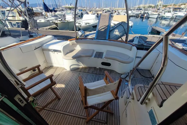  Yacht Photos Pics Luxurious 2007 Prestige 46 yacht deck with seating, docked at marina.