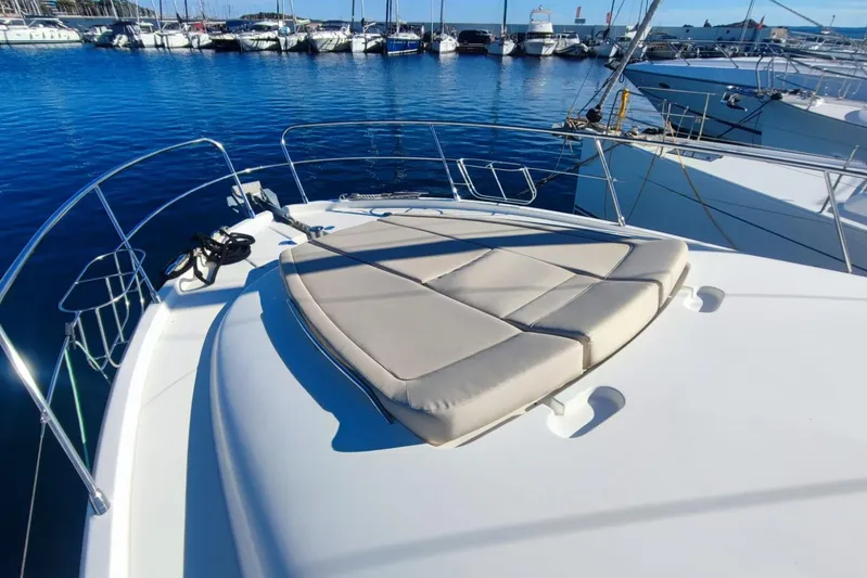  Yacht Photos Pics 2007 Prestige 46 yacht with sunbathing area, docked in a marina.