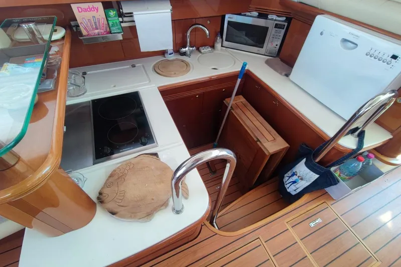  Yacht Photos Pics Kitchen area of a 2007 Prestige 46 yacht with appliances and wooden flooring.