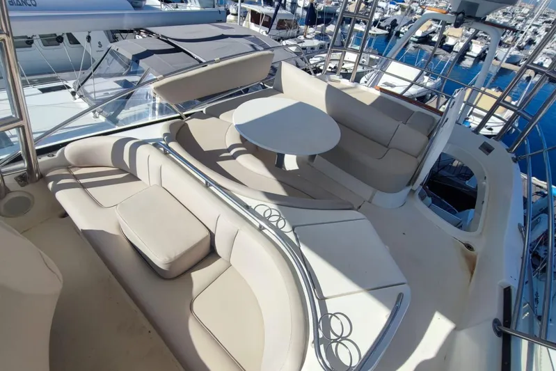  Yacht Photos Pics Luxurious seating area on a 2007 Prestige 46 yacht, docked at a marina.