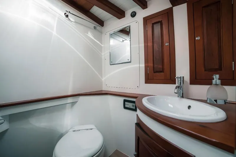 Spirit R74 Yacht Photos Pics Luxurious yacht bathroom with wooden cabinets, modern sink, and toilet, Spirit R74, 2014 model.