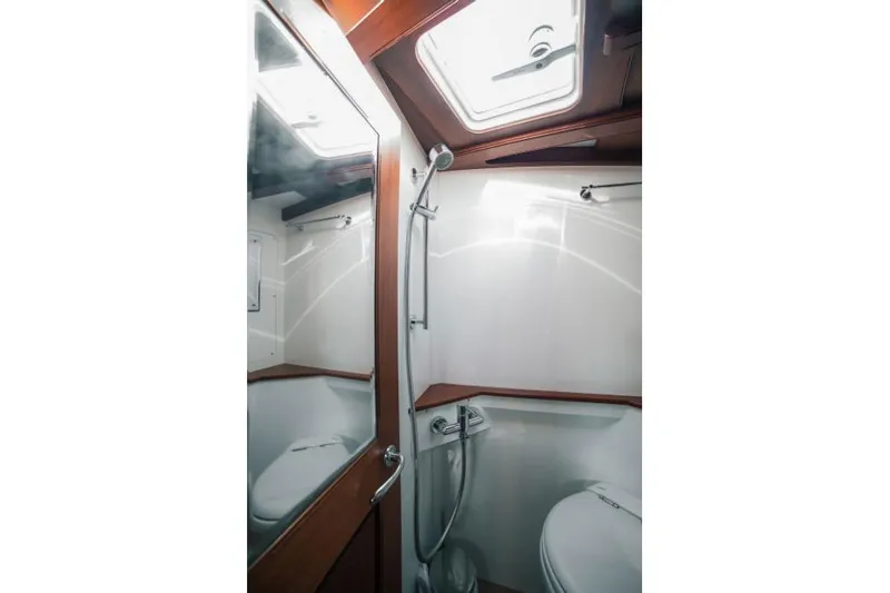 Spirit R74 Yacht Photos Pics 2014 Spirit R74 yacht bathroom with shower, mirror, and wooden accents.