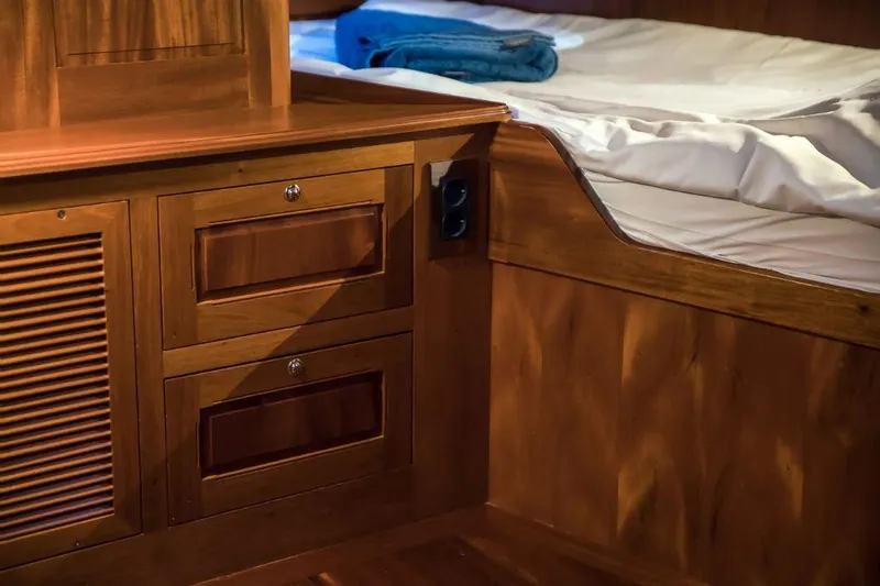 Spirit R74 Yacht Photos Pics Wooden interior of a 2014 Spirit R74 yacht with bed and storage drawers.