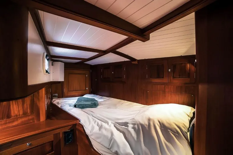 Spirit R74 Yacht Photos Pics Luxurious wooden cabin interior of 2014 Spirit R74 yacht with cozy bed and porthole.