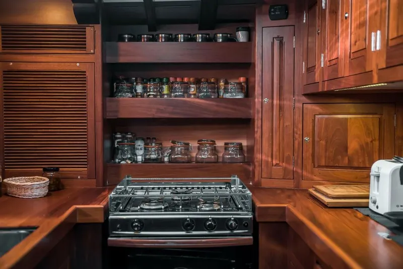 Spirit R74 Yacht Photos Pics Luxurious wooden yacht kitchen with stove, spice rack, and cabinets, Spirit R74, 2014 model.