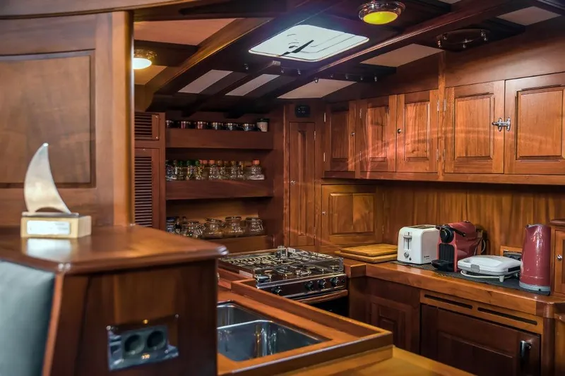 Spirit R74 Yacht Photos Pics Luxurious wooden yacht kitchen interior, Spirit R74, 2014 model, featuring modern appliances and elegant cabinetry.