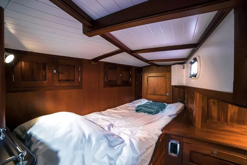 Spirit R74 Yacht Photos Pics Cozy wooden cabin interior of 2014 Spirit R74 yacht with bed and porthole.