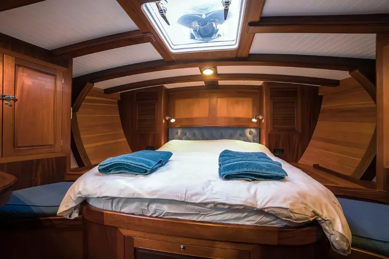 Spirit R74 Yacht Photos Pics Luxurious wooden cabin interior of 2014 Spirit R74 yacht with cozy bed and skylight.