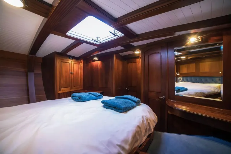 Spirit R74 Yacht Photos Pics Luxurious wooden cabin interior of 2014 Spirit R74 yacht with cozy bedding.