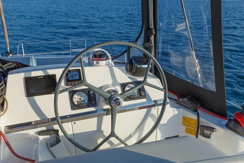  Yacht Photos Pics Steering wheel of a 2020 Bali 4.1 yacht with navigation instruments, overlooking the ocean.