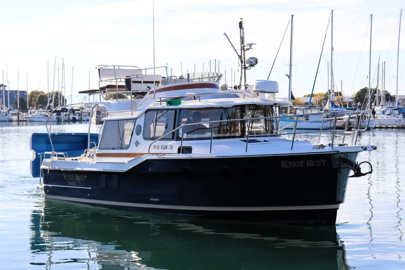 Knot Busy Yacht Photos Pics 2017 Ranger Tugs R-29 CB boat docked in marina, surrounded by sailboats.