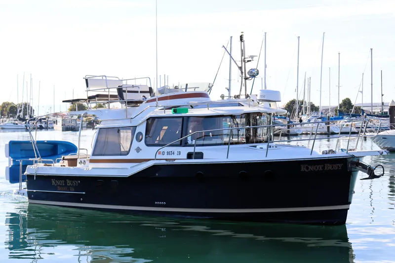 Knot Busy Yacht Photos Pics 2017 Ranger Tugs R-29 CB boat docked in a marina, named "Knot Busy."