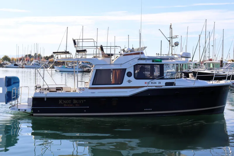 Knot Busy Yacht Photos Pics 2017 Ranger Tugs R-29 CB boat docked in a marina, surrounded by other vessels.