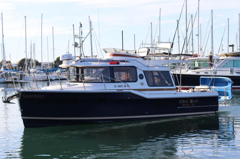 Knot Busy Yacht Photos Pics 2017 Ranger Tugs R-29 CB boat docked in marina, surrounded by sailboats.