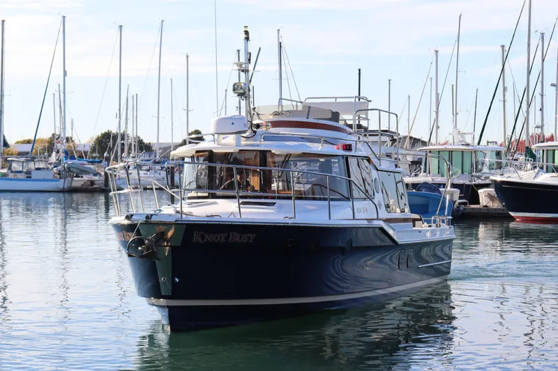 Knot Busy Yacht Photos Pics 2017 Ranger Tugs R-29 CB boat docked in a marina with sailboats.