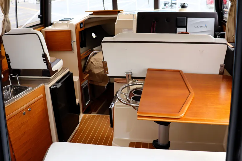 Knot Busy Yacht Photos Pics Interior of 2017 Ranger Tugs R-29 CB boat with wood accents and compact design.