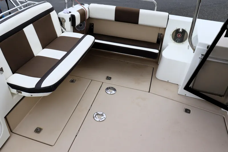 Knot Busy Yacht Photos Pics 2017 Ranger Tugs R-29 CB boat interior with cushioned seating and storage compartments.