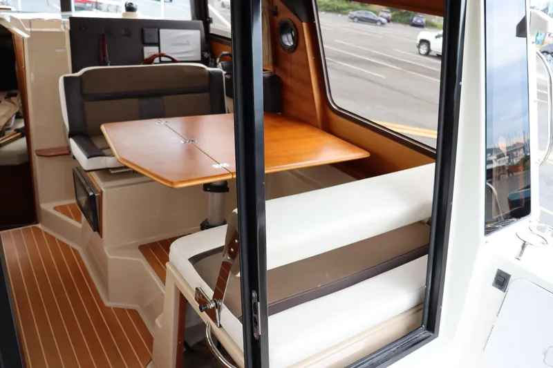 Knot Busy Yacht Photos Pics 2017 Ranger Tugs R-29 CB interior with dining area and wood accents.