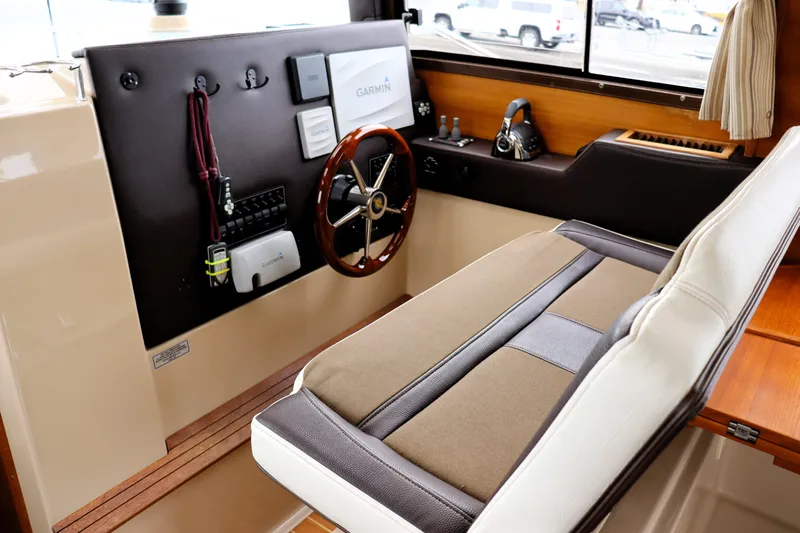 Knot Busy Yacht Photos Pics 2017 Ranger Tugs R-29 CB helm with steering wheel and navigation equipment.