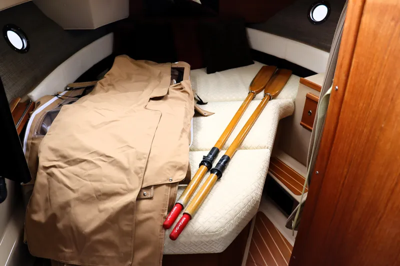 Knot Busy Yacht Photos Pics 2017 Ranger Tugs R-29 CB cabin interior with oars and beige cover.