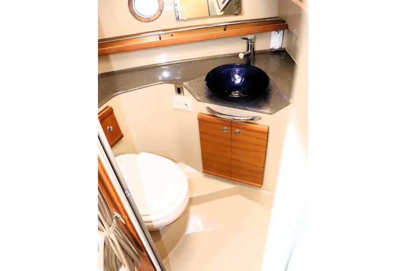 Knot Busy Yacht Photos Pics 2017 Ranger Tugs R-29 CB bathroom with modern sink and wooden cabinetry.
