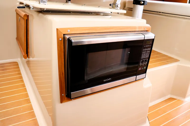 Knot Busy Yacht Photos Pics Microwave in 2017 Ranger Tugs R-29 CB boat interior with wood accents.