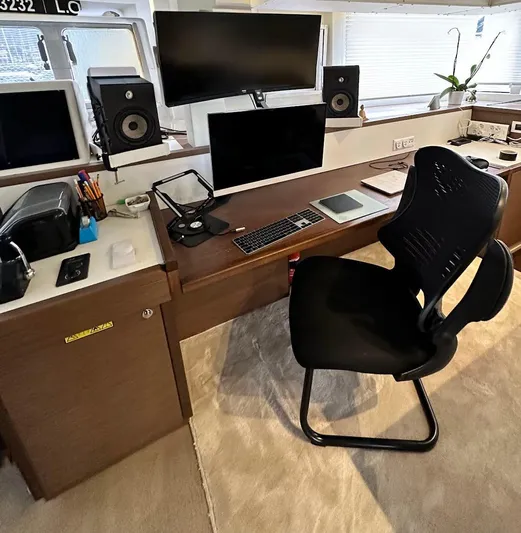 Topdog Yacht Photos Pics Modern workspace on a 2018 Lagoon 560 S2 yacht with dual monitors and speakers.