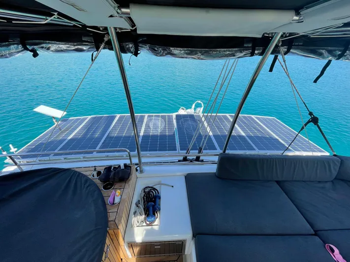 Topdog Yacht Photos Pics 2018 Lagoon 560 S2 yacht with solar panels on deck, overlooking clear blue water.