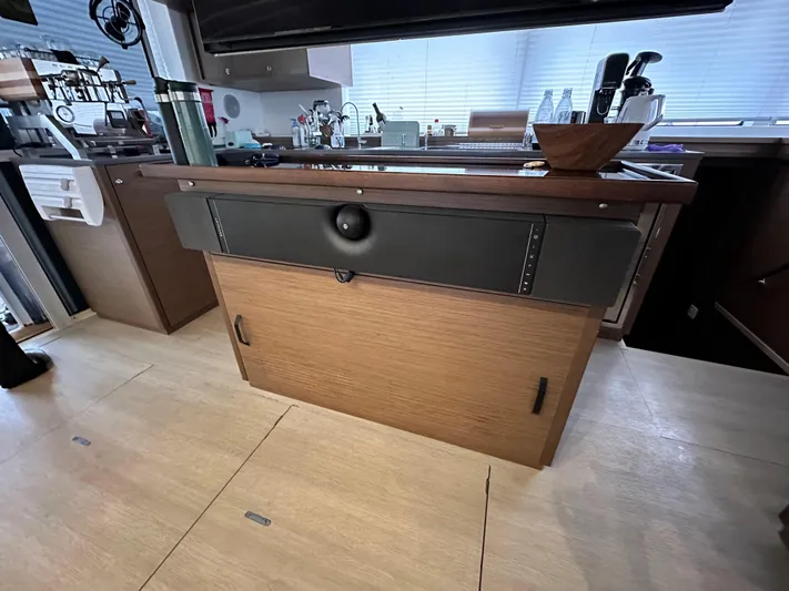 Topdog Yacht Photos Pics Interior of 2018 Lagoon 560 S2 yacht kitchen with wooden cabinetry and modern appliances.