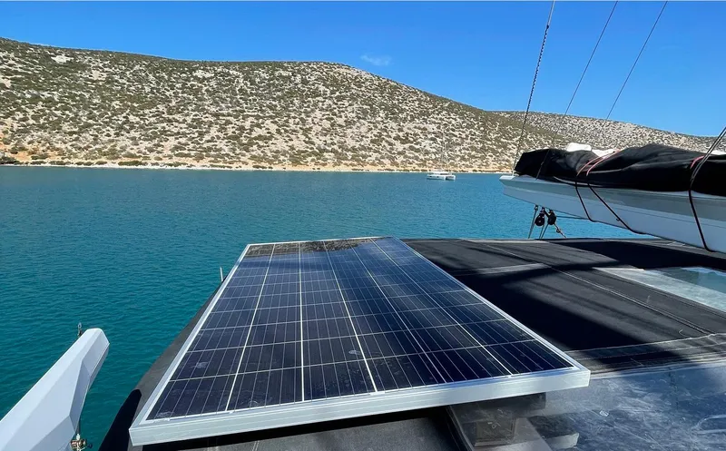 Topdog Yacht Photos Pics Solar panel on Lagoon 560 S2 yacht, 2018 model, with scenic coastal backdrop.