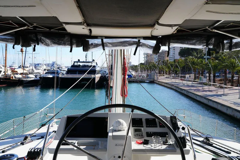 Topdog Yacht Photos Pics Cockpit view from a 2018 Lagoon 560 S2 yacht docked in a marina.
