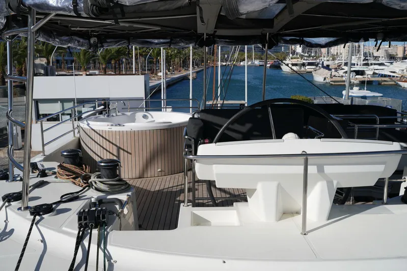Topdog Yacht Photos Pics Lagoon 560 S2 yacht deck with steering wheel and hot tub, docked at marina, 2018 model.