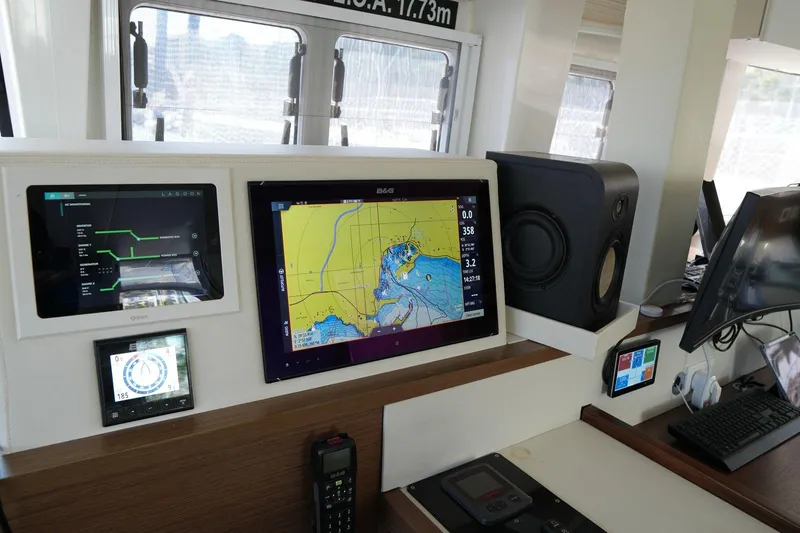 Topdog Yacht Photos Pics Control panel of a 2018 Lagoon 560 S2 yacht with navigation screens and equipment.