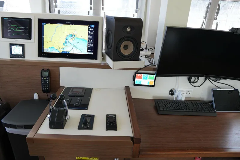 Topdog Yacht Photos Pics Control panel of a 2018 Lagoon 560 S2 yacht with navigation equipment and monitors.