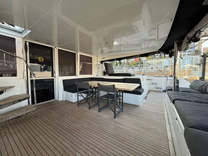 Topdog Yacht Photos Pics Spacious deck of 2018 Lagoon 560 S2 yacht with seating and dining area.