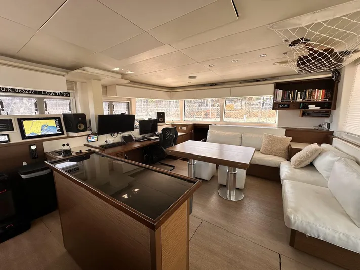 Topdog Yacht Photos Pics Interior of 2018 Lagoon 560 S2 yacht with modern navigation equipment and comfortable seating.