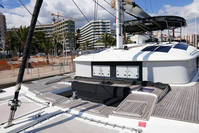 Topdog Yacht Photos Pics 2018 Lagoon 560 S2 yacht deck with cityscape and palm trees in the background.
